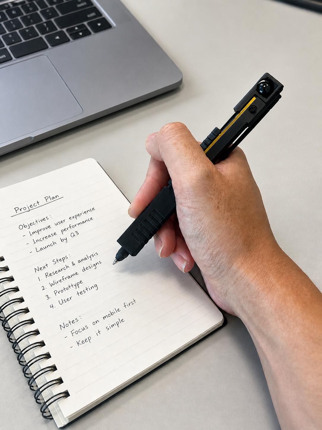 Pureaxial used while writing notes at a work desk